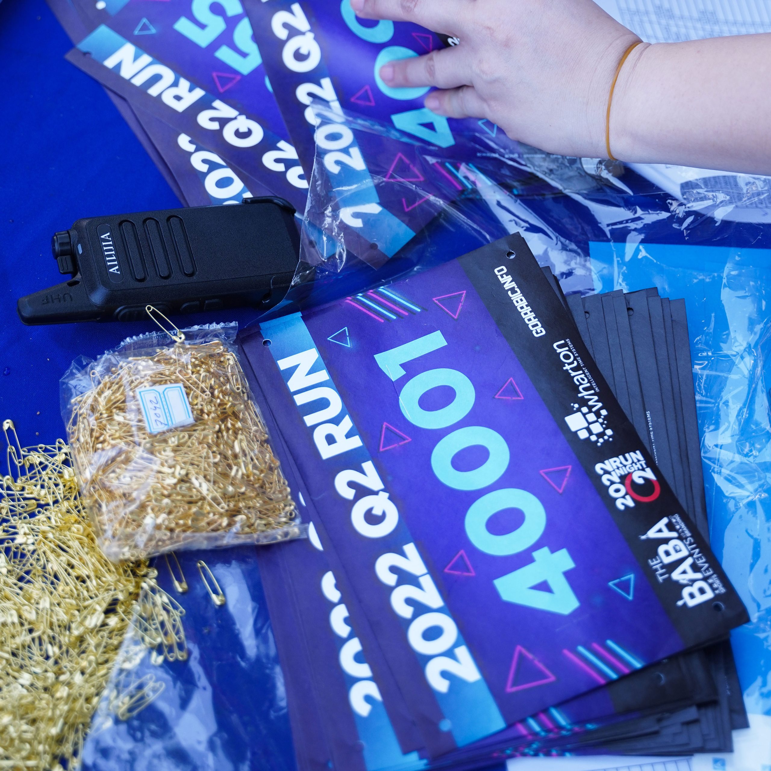 A vibrant banner reading "Now Open" positioned centrally in a yard, signaling the start of business or activity.