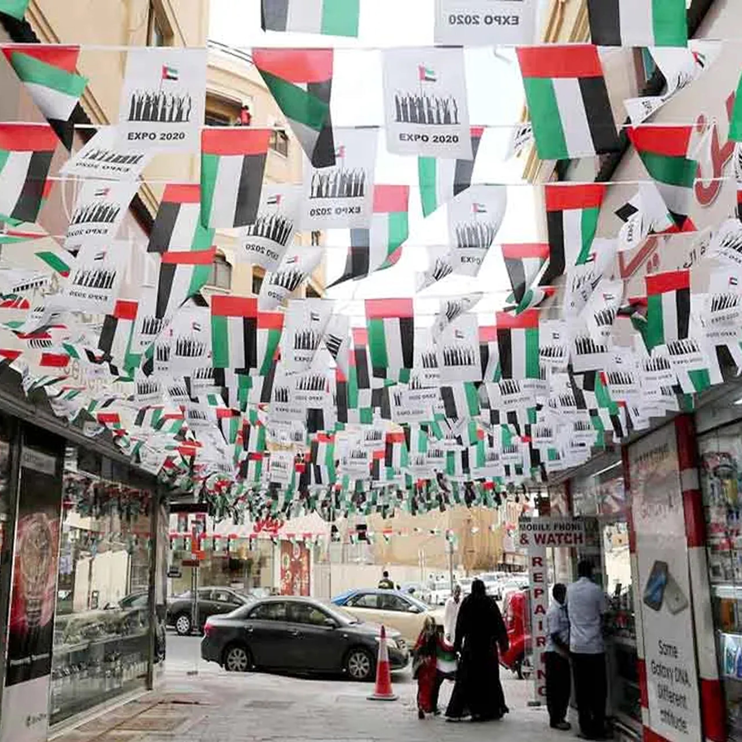 street filled with vibrant bunting flags suspended overhead